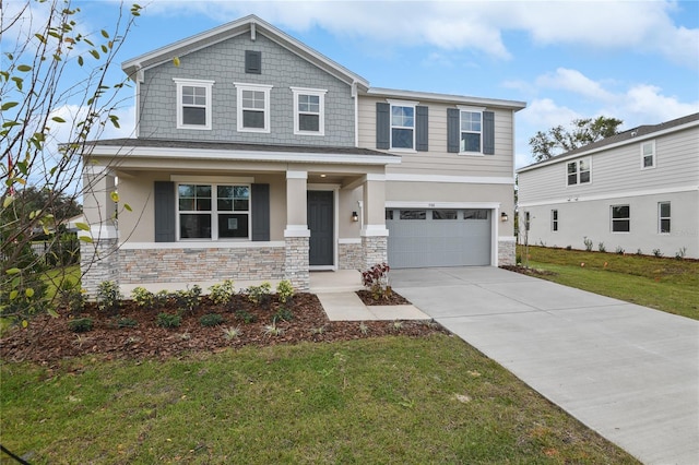 view of front of house with a porch, a garage, and a front yard