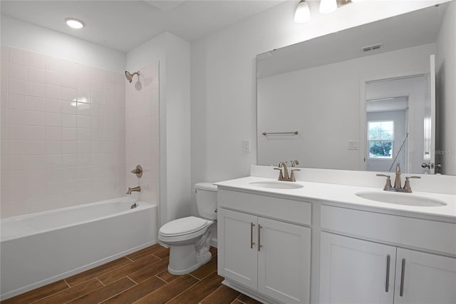 full bathroom featuring vanity, toilet, and shower / tub combination