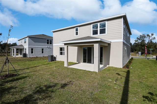 rear view of property featuring a patio, central AC unit, and a lawn