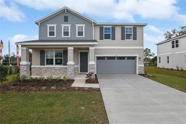 view of front of home featuring a porch, a front yard, and a garage