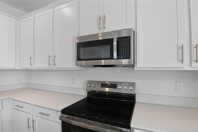 kitchen with stainless steel appliances and white cabinetry