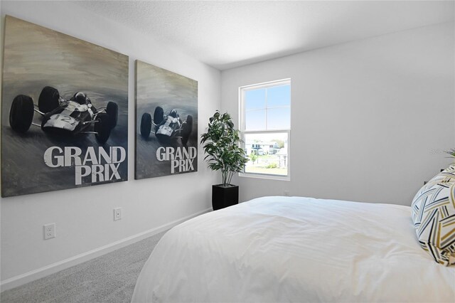500 Summit River Dr, Apopka, FL 32712 - carpeted bedroom with baseboards and a textured ceiling