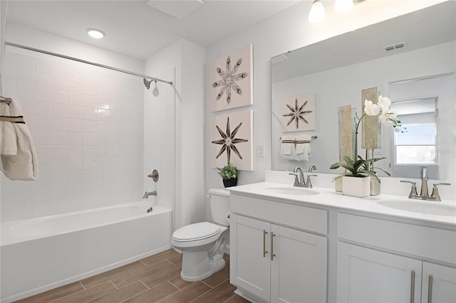 500 Summit River Dr, Apopka, FL 32712 - full bath with wood tiled floor, visible vents, a sink, and toilet