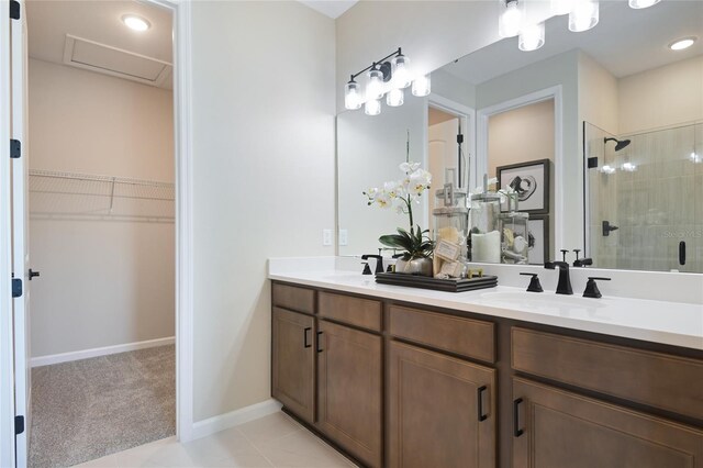 bathroom with tile patterned floors, walk in shower, and vanity