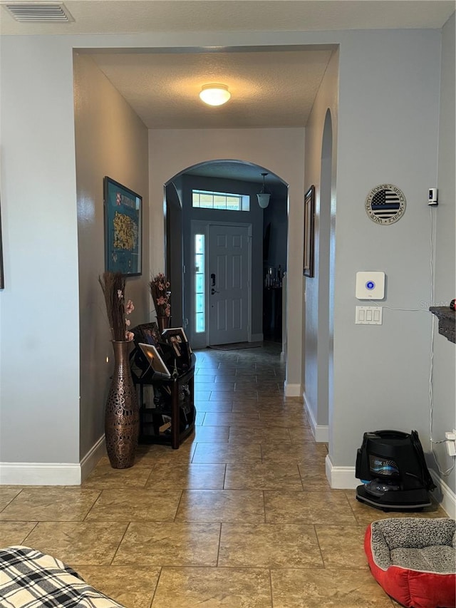 foyer entrance featuring a textured ceiling