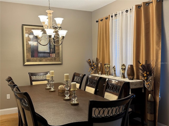 dining area with a chandelier and light hardwood / wood-style floors