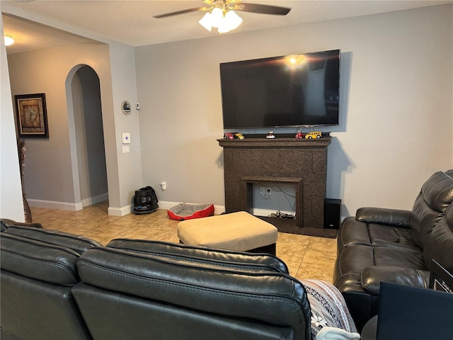 living room featuring light tile patterned flooring and ceiling fan