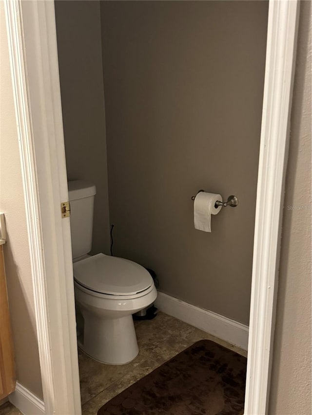 bathroom featuring toilet and tile patterned floors