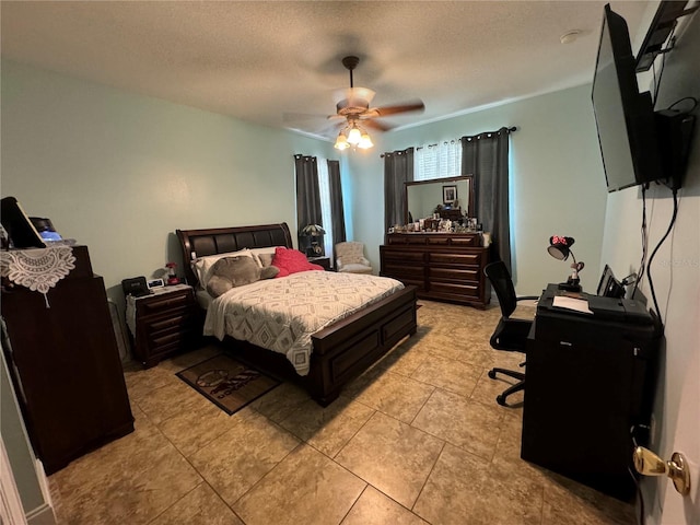 tiled bedroom with ceiling fan and a textured ceiling