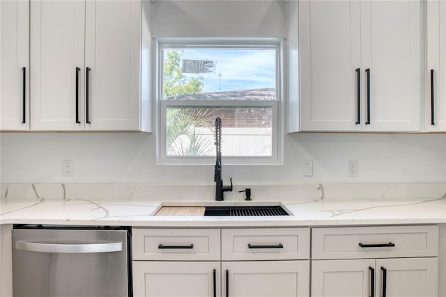 kitchen featuring white cabinets, light stone countertops, and dishwasher