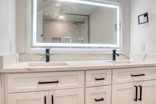 bathroom featuring a tile shower and vanity