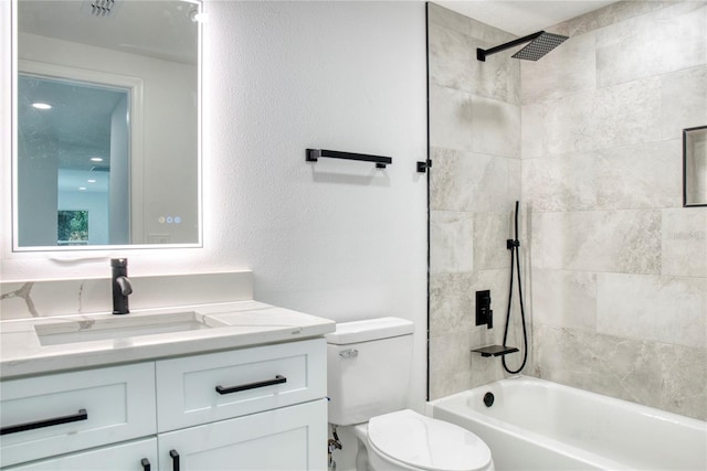 full bathroom with vanity, toilet, and tiled shower / bath combo