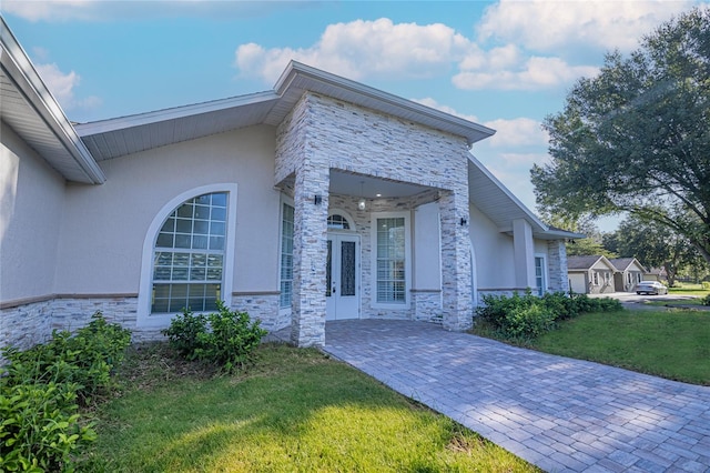 view of home's exterior featuring a lawn and a patio