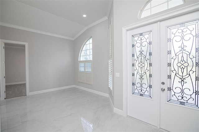 entryway featuring lofted ceiling and ornamental molding