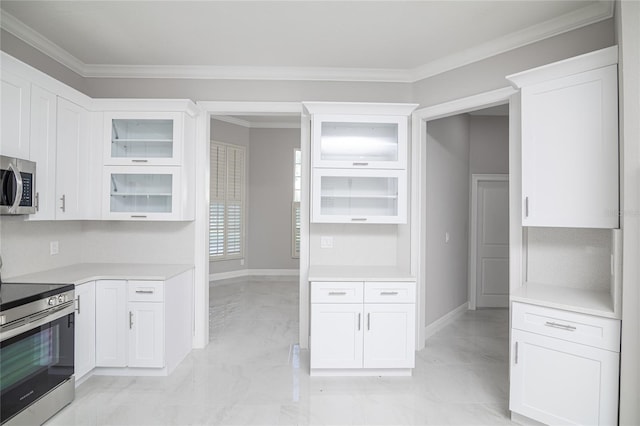 kitchen featuring crown molding, stainless steel appliances, and white cabinets