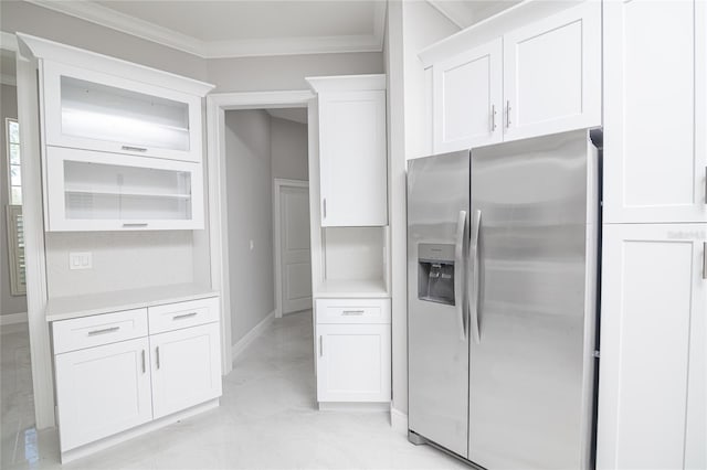 kitchen with ornamental molding, white cabinetry, and stainless steel fridge with ice dispenser