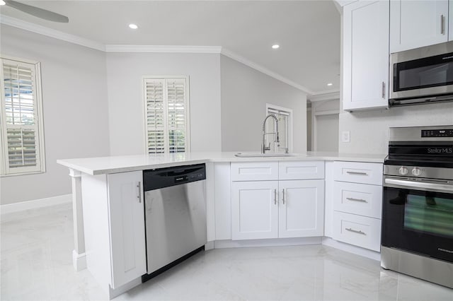 kitchen with stainless steel appliances, plenty of natural light, sink, and white cabinetry