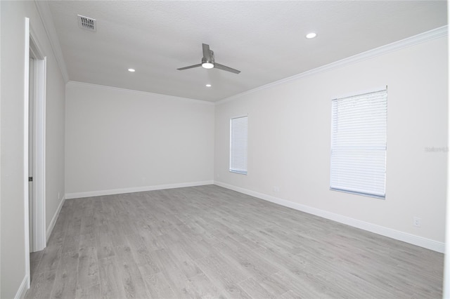 empty room featuring ceiling fan, a textured ceiling, light hardwood / wood-style flooring, and ornamental molding