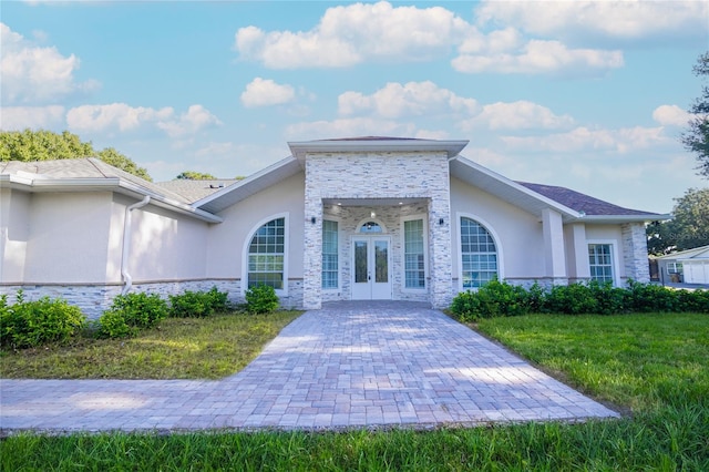 view of front of house with french doors and a front yard