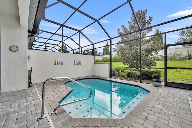 view of swimming pool featuring a patio area and glass enclosure