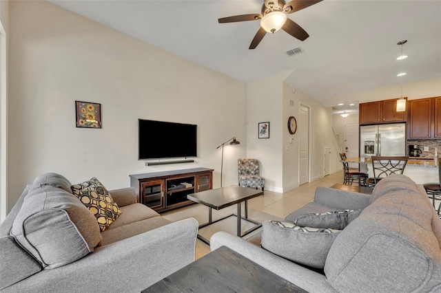 tiled living room featuring ceiling fan