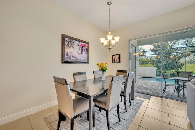 dining room with light tile patterned floors and an inviting chandelier