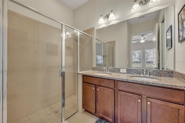 bathroom featuring vanity, a shower with shower door, ceiling fan, and tile patterned flooring