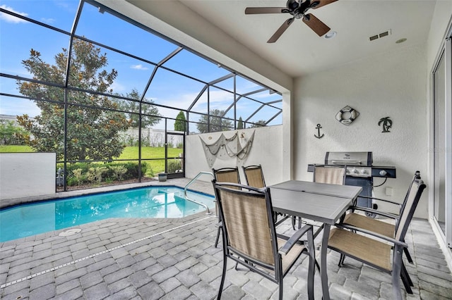 view of swimming pool with a grill, ceiling fan, a patio, and a lanai