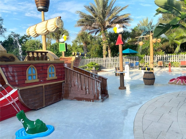 view of playground with a patio area