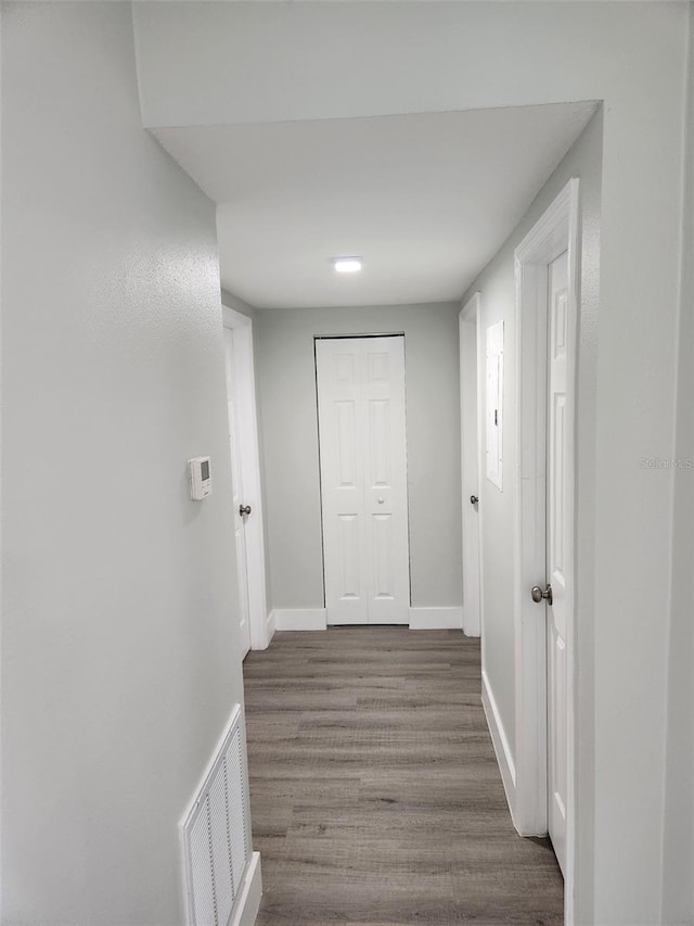 corridor featuring dark hardwood / wood-style flooring