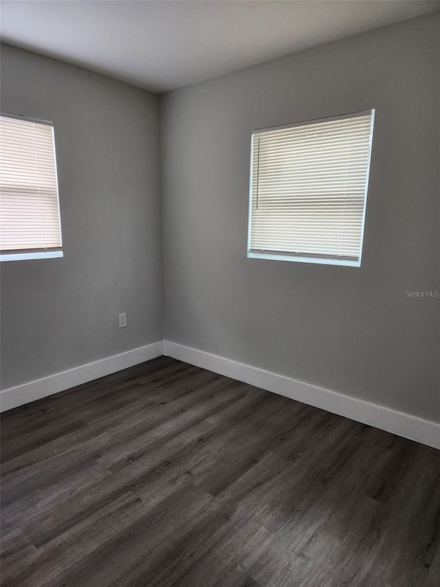 spare room featuring dark hardwood / wood-style flooring