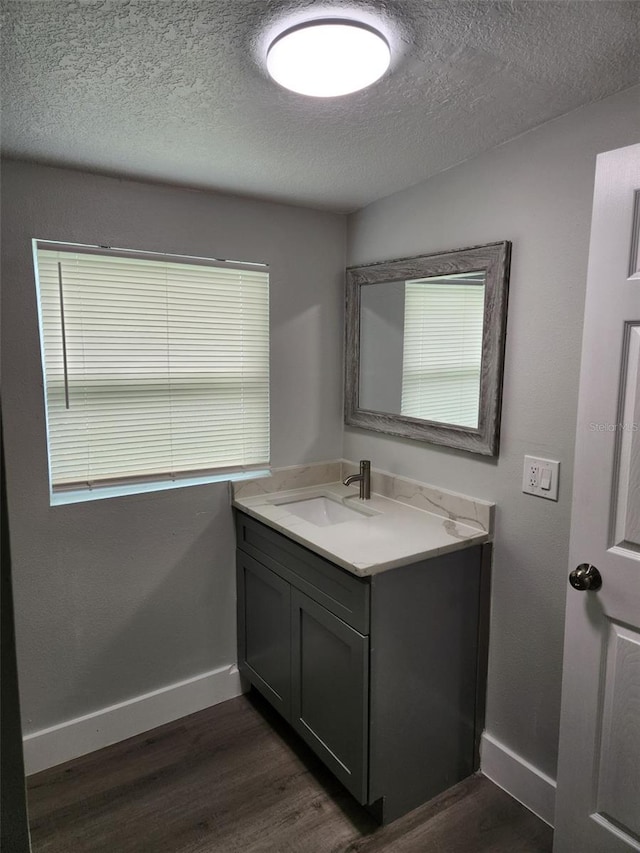 bathroom featuring a textured ceiling, vanity, and hardwood / wood-style flooring