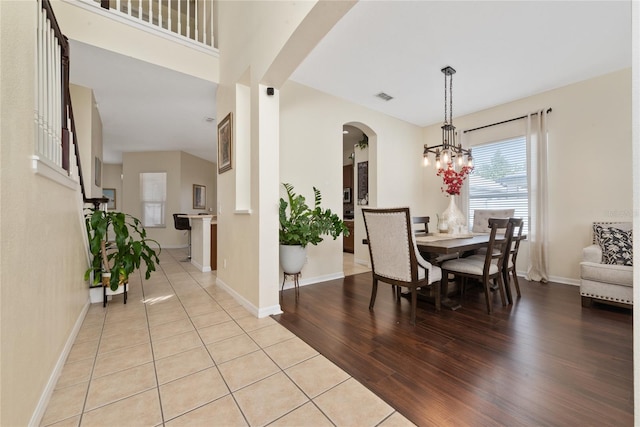 dining space featuring a notable chandelier and light hardwood / wood-style floors