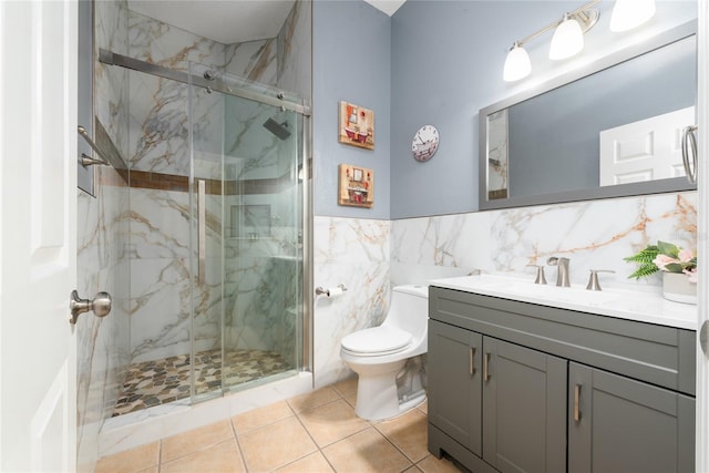 bathroom featuring vanity, toilet, tile patterned floors, and a shower with door