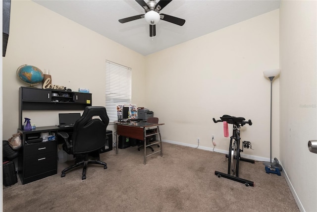 carpeted office space featuring ceiling fan