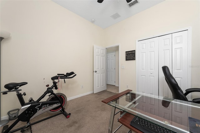 workout room featuring ceiling fan and light carpet