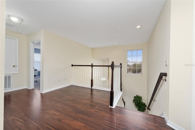 empty room with dark hardwood / wood-style floors