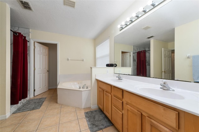 bathroom with tile patterned flooring, vanity, independent shower and bath, and a textured ceiling