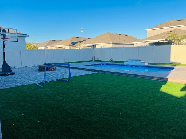 view of yard featuring a fenced in pool and a patio