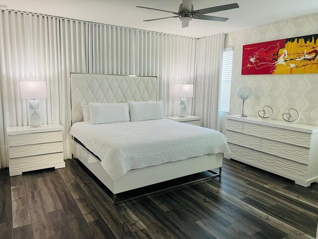 bedroom with dark wood-type flooring and ceiling fan