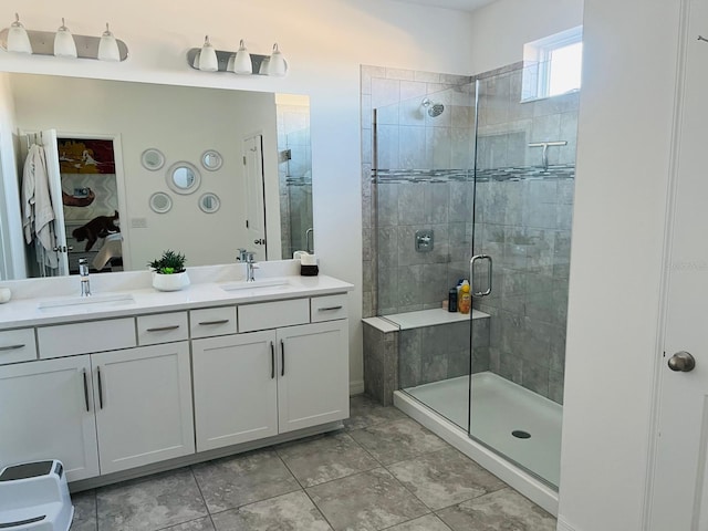 bathroom with a shower with shower door and vanity