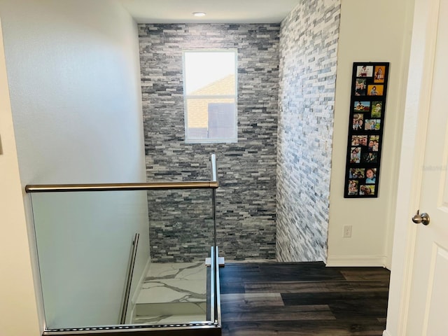 bathroom with hardwood / wood-style flooring and a shower with shower door