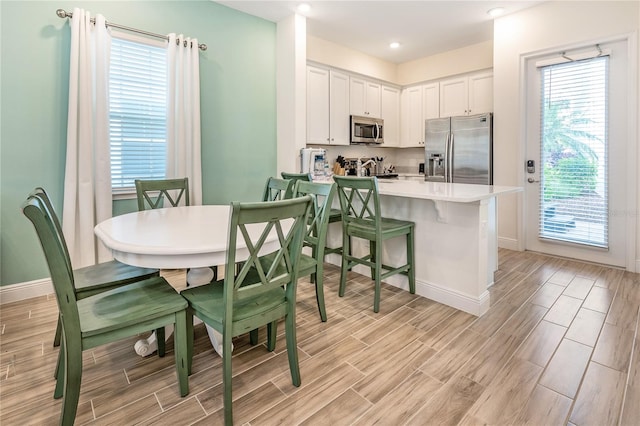 dining space with light wood-type flooring