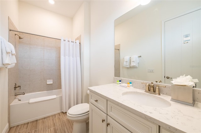 full bathroom featuring vanity, toilet, hardwood / wood-style flooring, and shower / bath combo with shower curtain