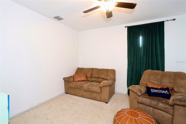 carpeted living room featuring ceiling fan