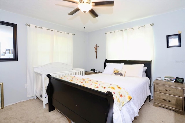 bedroom featuring light carpet and ceiling fan