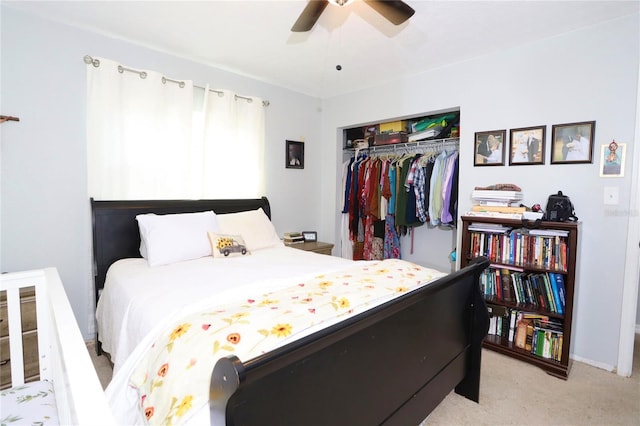 bedroom featuring ceiling fan, a closet, and light colored carpet