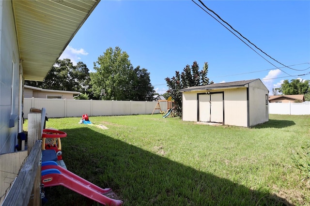 view of yard with a playground and a shed