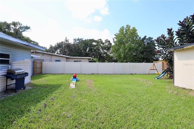 view of yard featuring a fenced backyard and a playground