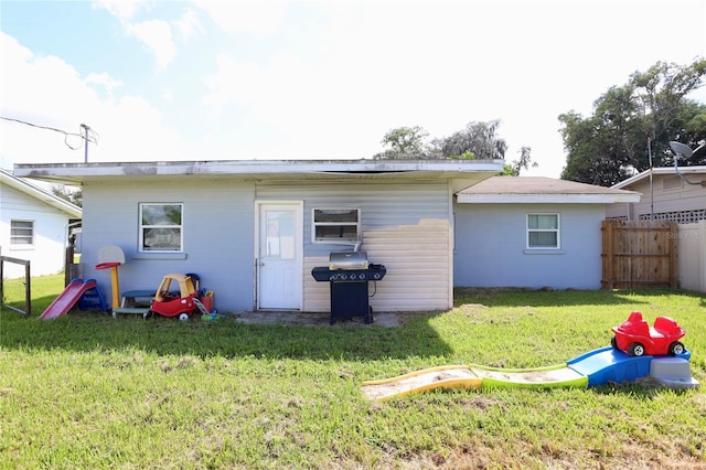 back of house featuring a lawn